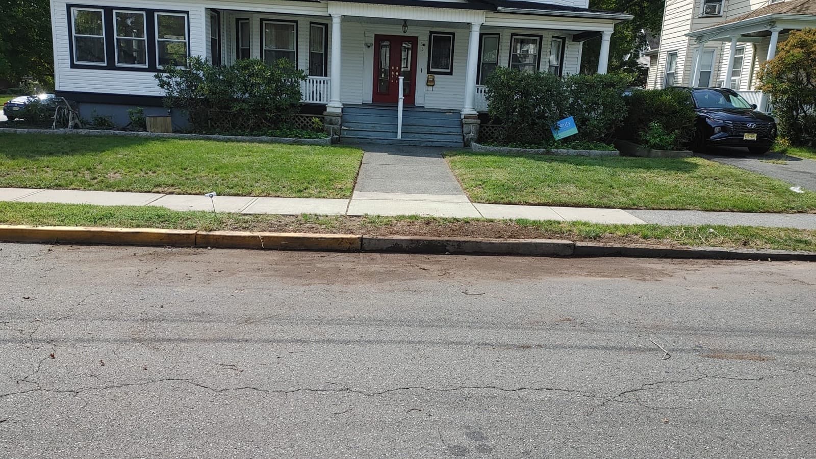 The same curb after Junk Vanisher removed the brush pile, completely clear.